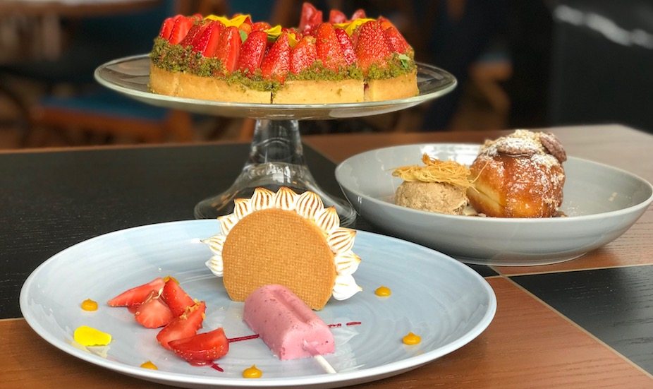 Strawberry and pistachio tart, yuzu and lemon tart and brioche donut with coffee ice cream at Origin grill and bar