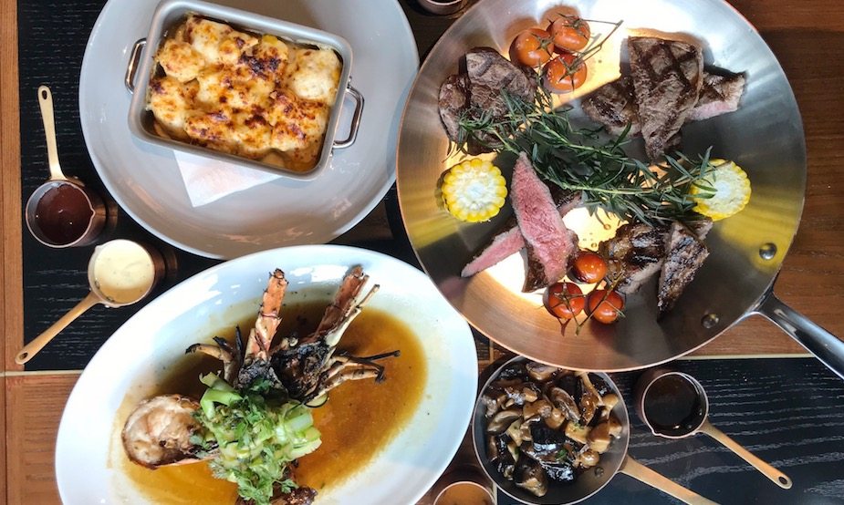 The Lombok lobster and steak platter, with baked cauliflower and mushrooms at Origin Grill and Bar.
