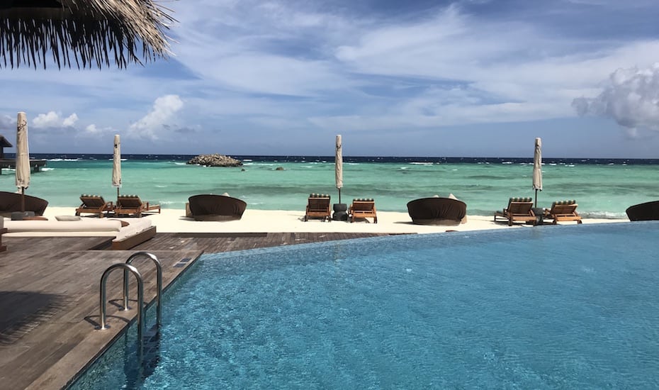 Main pool at The Residence Maldives overlooks the white sand beach.