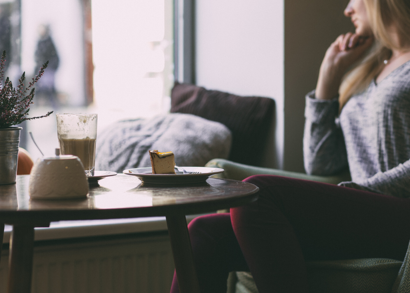 woman sitting alone at cafe with coffee