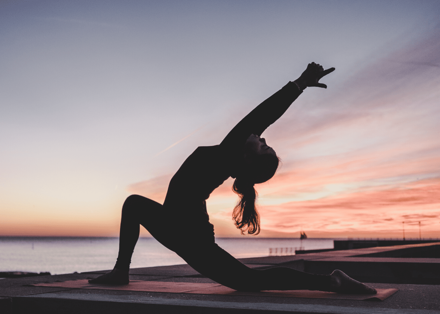 woman doing yoga at sunset | exercise regularly to boost your immunity