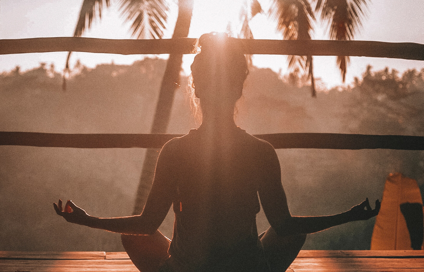 woman meditating at sunset