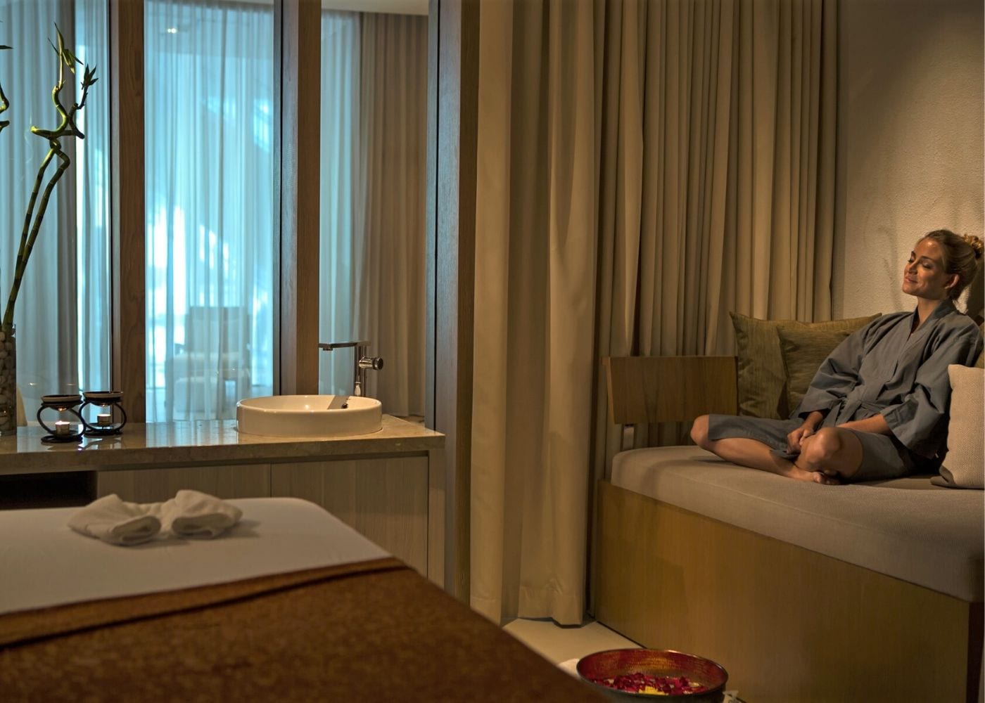 A woman enjoying the spa room at The Stones - Legian, Bali hotel