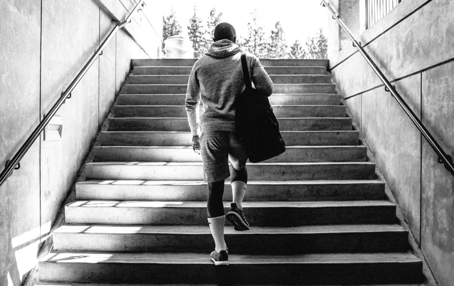 men's activewear in hong kong man walking up stairs