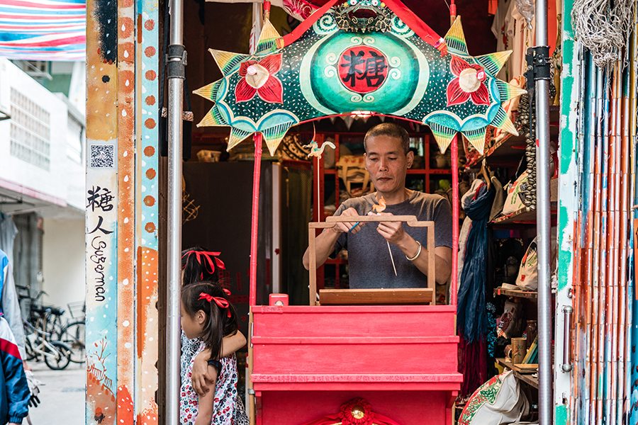 sugarman louis to in front of his cheung chau store
