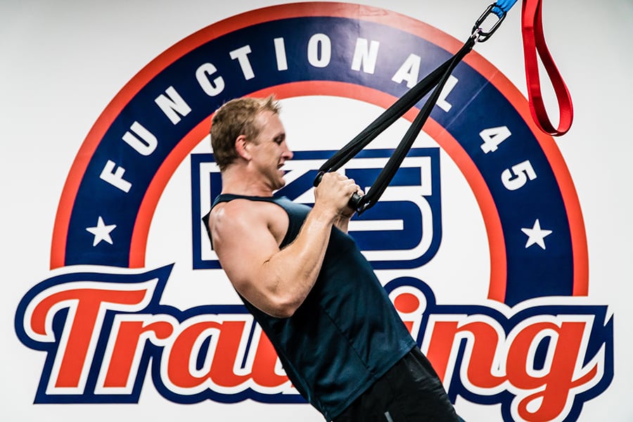 f45 training sai ying pun man pulling up on TRX