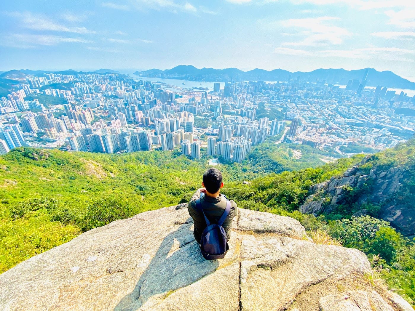 person sitting on the edge of the cliff